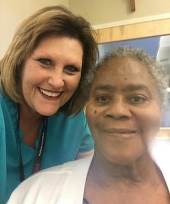 Smiling staff member with resident in a care facility