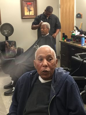 Residents getting haircuts in a salon area
