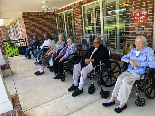 Residents enjoying fresh air on a porch