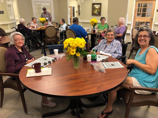 Residents enjoying a bingo game in a common area