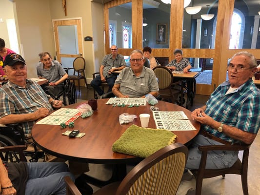 Residents enjoying bingo in a common area
