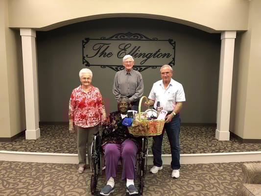Residents posing with a basket in the activity room
