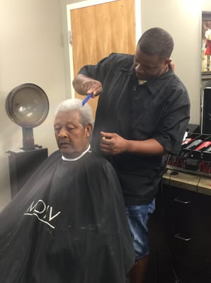 A resident getting a haircut in a salon