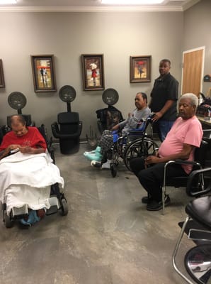Residents in a salon with hairdryers and wheelchair access