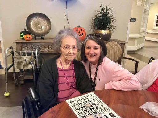 Resident playing bingo with staff member