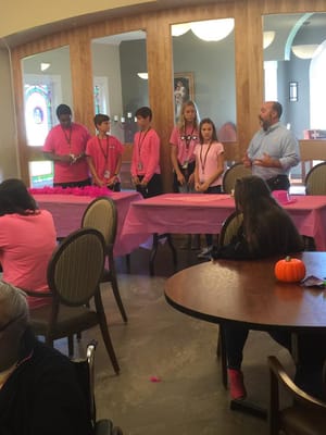 Residents and staff engaging in a lively activity at a table