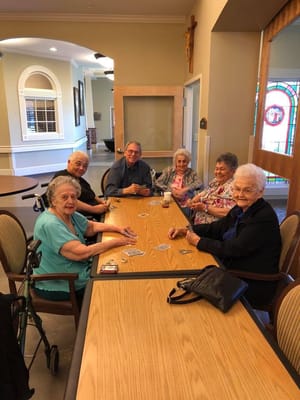 Residents engaged in a card game in a common area
