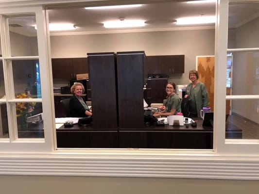 Staff members at the front desk in a facility office
