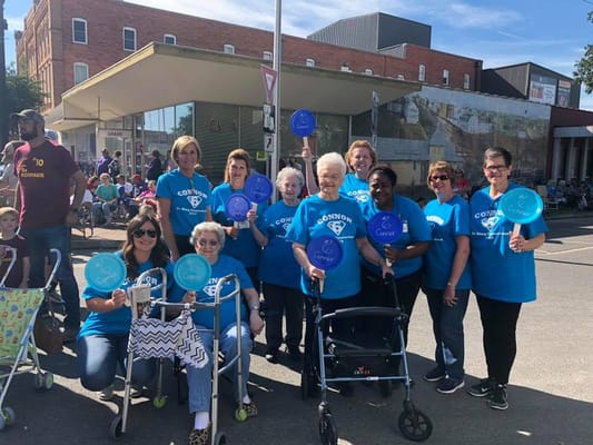 Residents and staff participating in a community event with signs