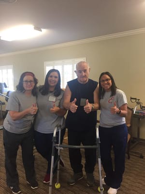 Staff and resident giving thumbs up in a common area