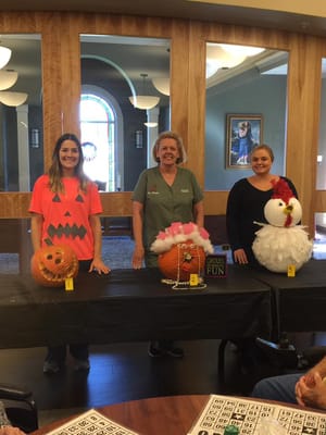 Residents and staff displaying creatively decorated pumpkins