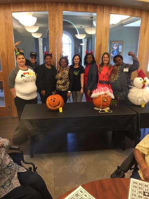 Staff and residents at a festive community event with pumpkins