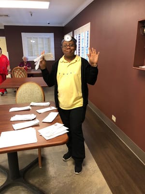 Staff member organizing papers in a common area