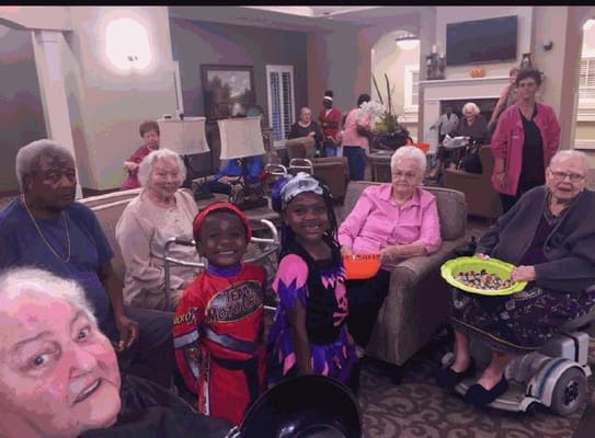 Residents and staff celebrating in a common area during an activity