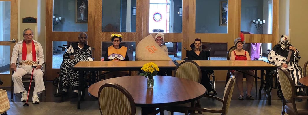 Residents in costumes enjoying an activity in the common area