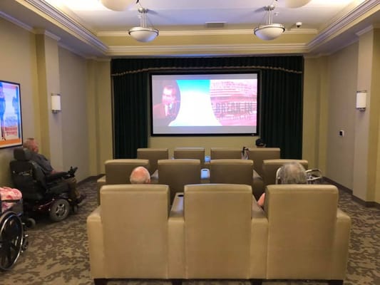 Residents watching a movie in the facility's theater