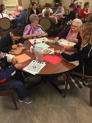 Residents participating in a bingo game in an activity room