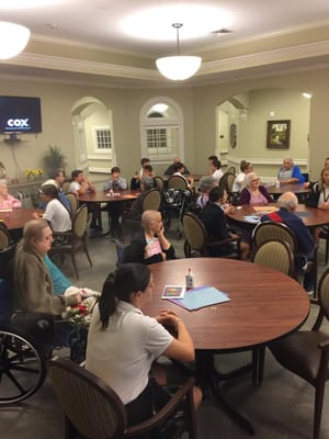 Residents and staff engaged in an activity in a common area
