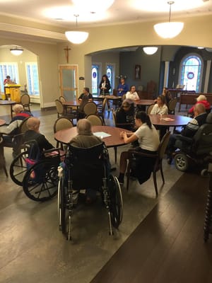 Residents participating in a group activity in a lounge area