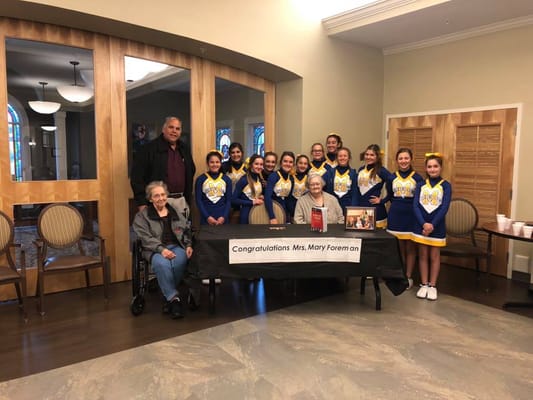 Residents celebrating with cheerleaders at an event