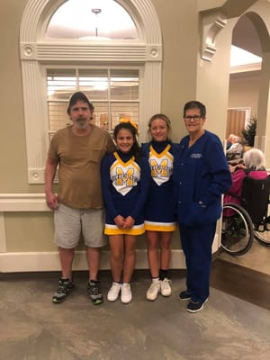 Residents and staff posing for a photo in the common area