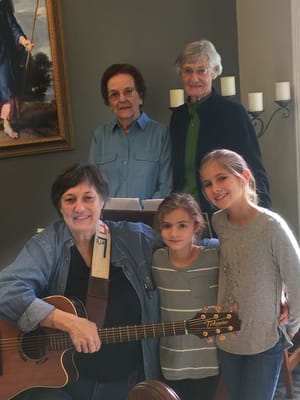 Residents and children enjoying music together indoors