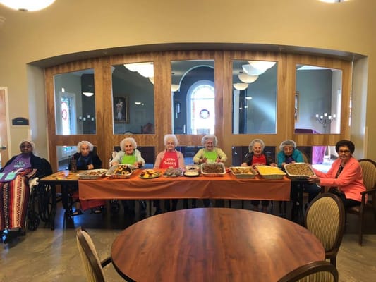 Residents enjoying a food activity in a common area.