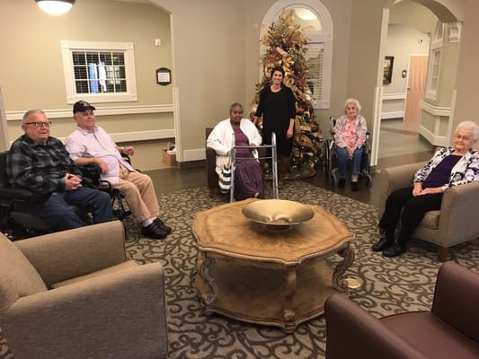 Residents and staff in a common area during the holidays