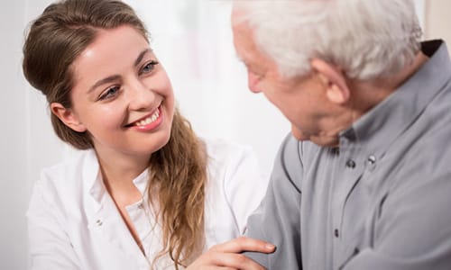 A caregiver smiling with a resident