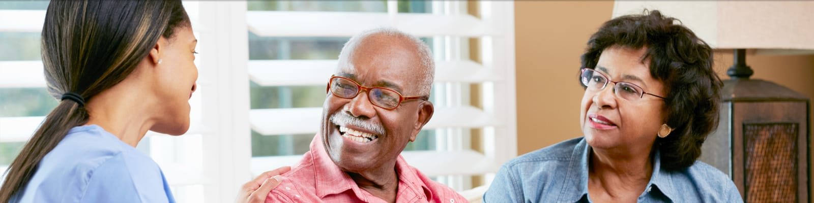 Residents engaging with staff in a cozy common area