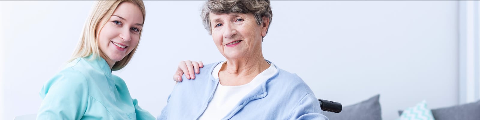A caregiver and a happy resident in a cozy common area