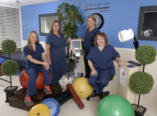 Staff members in therapy room with exercise equipment
