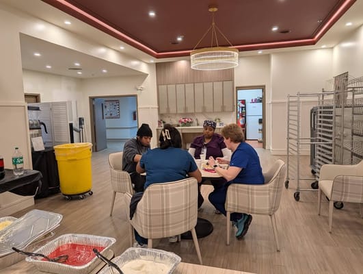 Staff members and residents engaged at a dining table