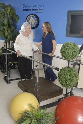 Resident participating in therapy with staff support