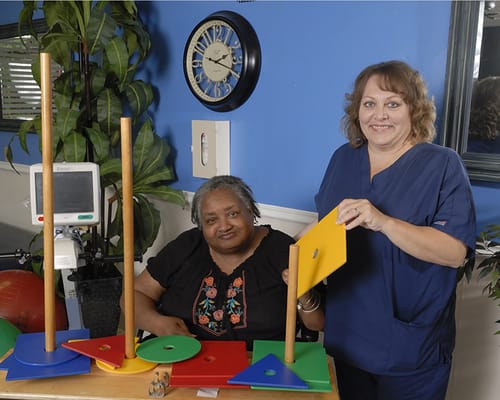 Staff member assisting a resident with an activity