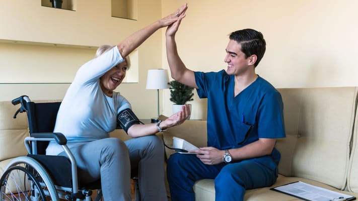 A nurse interacting with a resident in a cozy living room