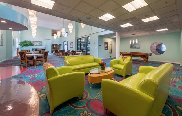 Bright common area with colorful seating and dining space