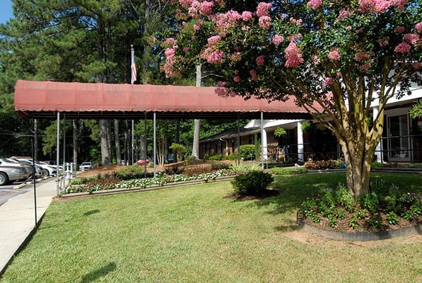 Exterior view of Pine Knoll Nursing & Rehab Center with landscaping