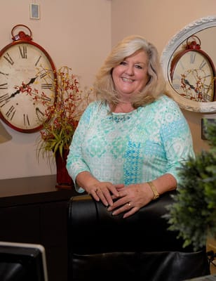 Staff member posing in an interior setting