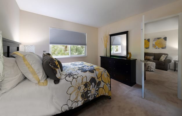 Comfortable resident room with floral bedding and sofa