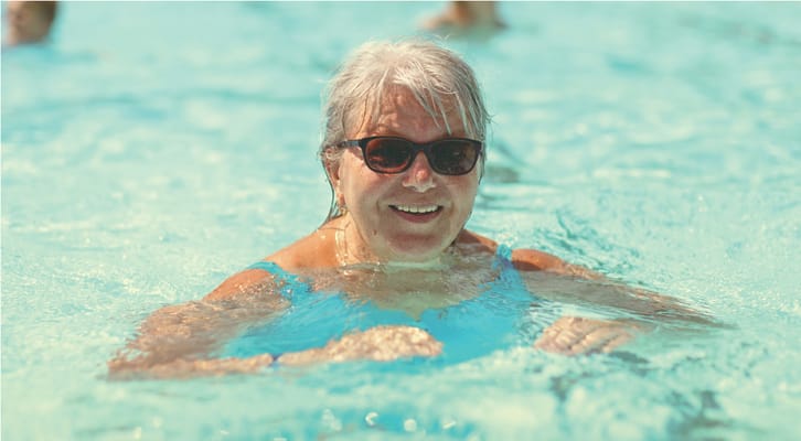 Senior woman enjoying swimming in a pool
