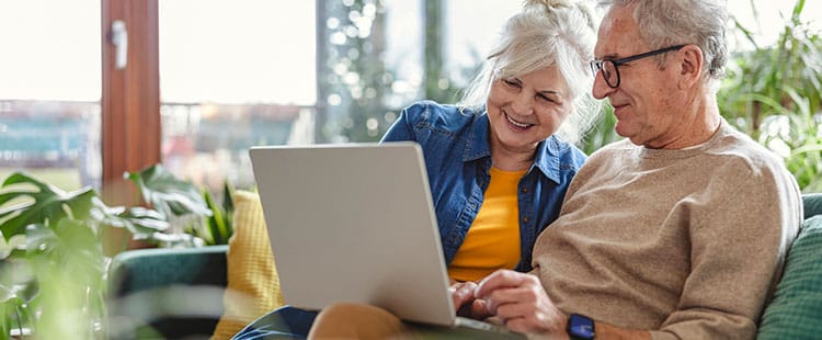 Couple enjoying time together on a laptop in a cozy lounge