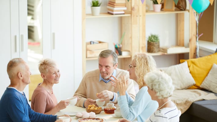 Residents enjoying tea and conversation in a communal space
