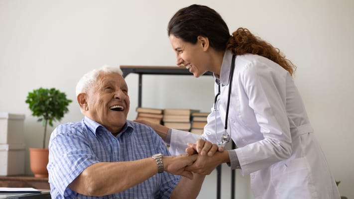 A cheerful interaction between a resident and a caregiver