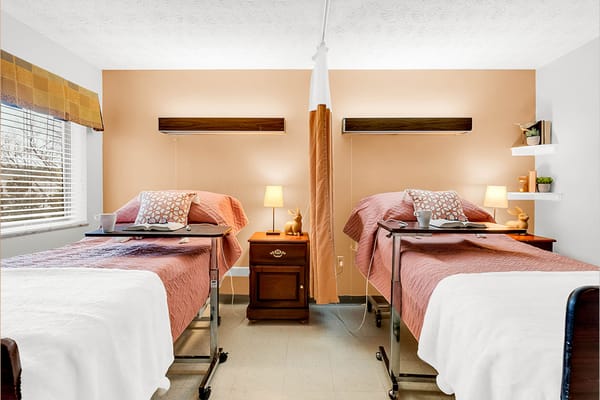 Cozy resident room with two beds and bedside tables