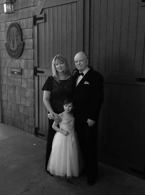 Family portrait outside a venue with wooden doors