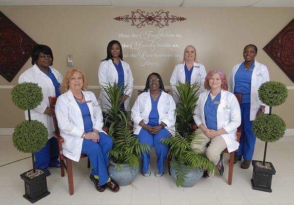 Staff members posing in a common area.