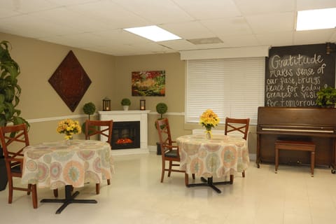 Bright common area with tables and a piano