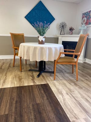 Casual seating area with a decorative table and vase