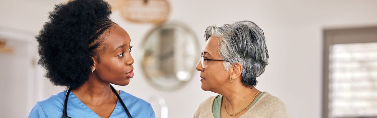 Healthcare worker talking with a resident